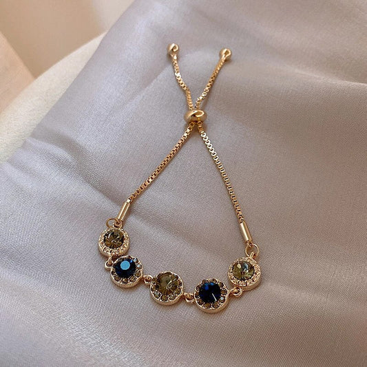 Pulsera elegante dorada ajustable de cristal redondo - Hipnotelia